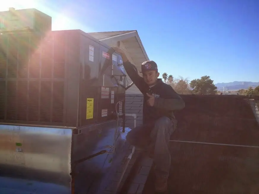 HVAC technician performing Boiler Repair on a rooftop unit in Bluffton